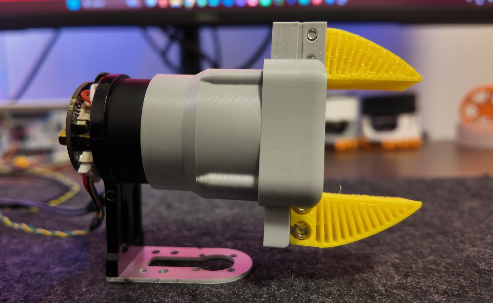 Upstream photograph of an Open-Gripper-mini build with yellow jaws. This is the maintainer’s build, not hardware tested by us.